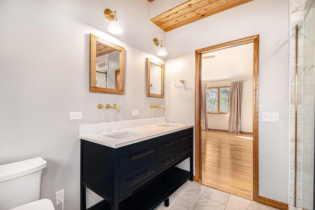 full bath with toilet, marble finish floor, and vanity