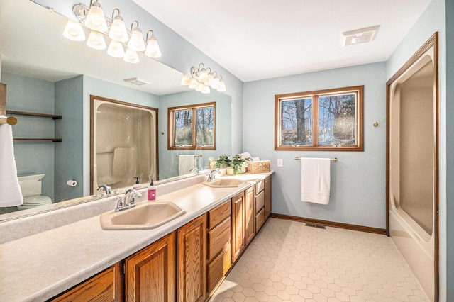 bathroom with visible vents, a sink, and walk in shower