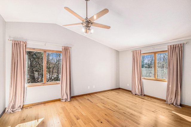 unfurnished room featuring vaulted ceiling, a ceiling fan, light wood-style flooring, and baseboards