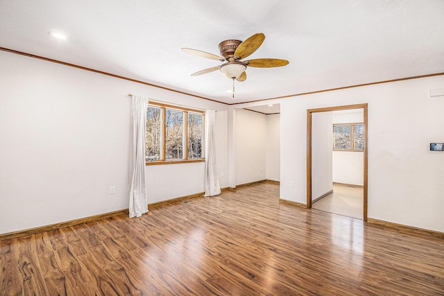 spare room featuring ornamental molding and wood finished floors