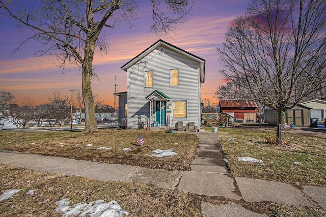 traditional home with a storage shed and an outbuilding