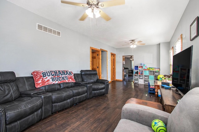 living room with a ceiling fan, visible vents, and wood finished floors