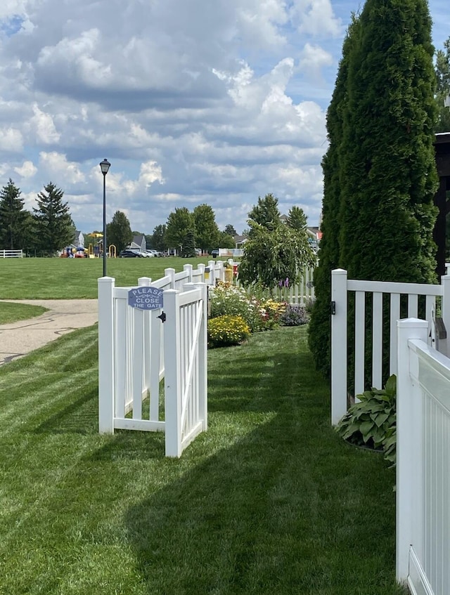 view of yard with fence and central AC unit