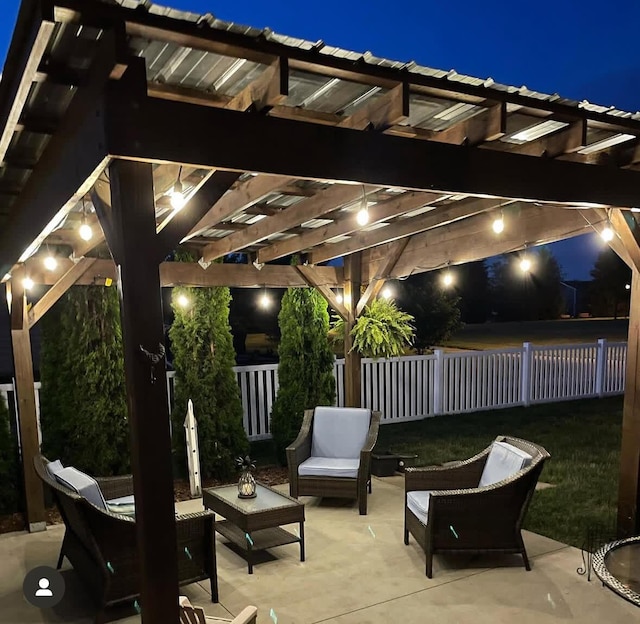 patio at twilight with fence, an outdoor hangout area, and a pergola