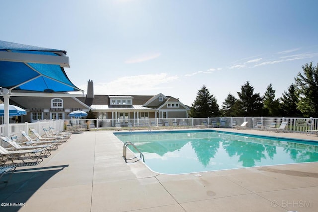 pool featuring fence and a patio