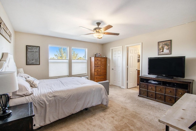 bedroom with light carpet and a ceiling fan