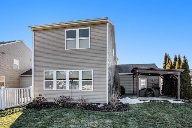 back of house featuring a patio and a yard