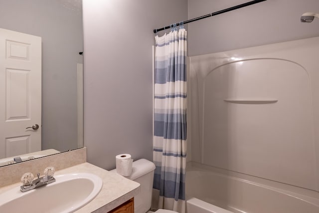 full bath with shower / bath combo, vanity, and toilet