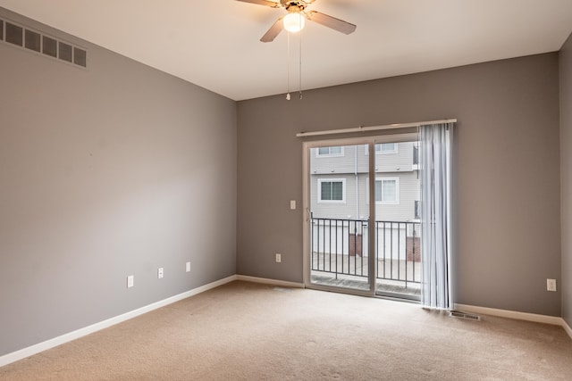 carpeted empty room with a ceiling fan, plenty of natural light, visible vents, and baseboards