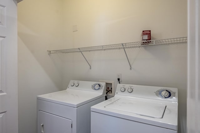 clothes washing area with laundry area and washer and clothes dryer