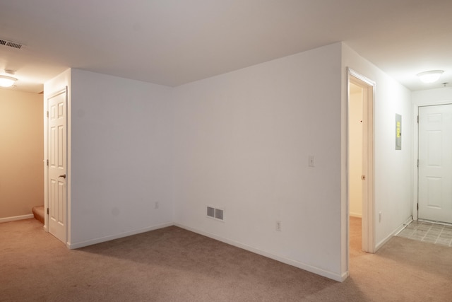 interior space with light carpet, visible vents, and baseboards