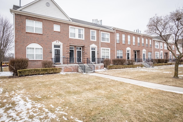 townhome / multi-family property featuring brick siding