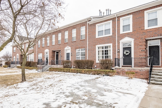 townhome / multi-family property featuring brick siding