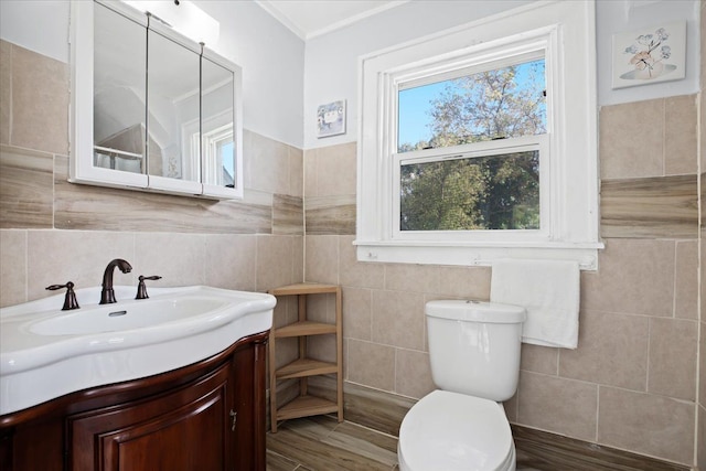 half bathroom featuring toilet, tile walls, and vanity