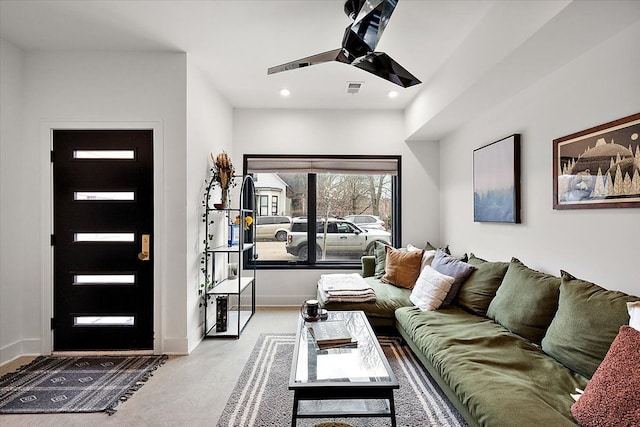 living area with a ceiling fan, recessed lighting, and baseboards