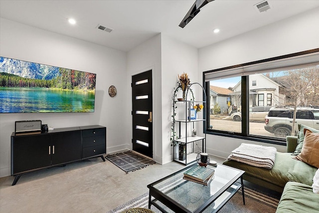 living area with recessed lighting, visible vents, and baseboards