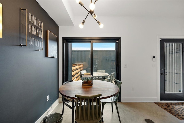 dining room with concrete floors and baseboards