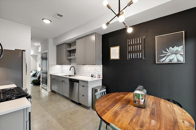 kitchen with visible vents, appliances with stainless steel finishes, gray cabinets, open shelves, and a sink