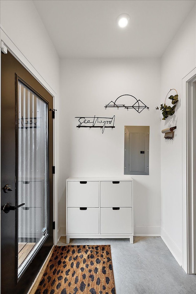 entryway featuring electric panel and baseboards