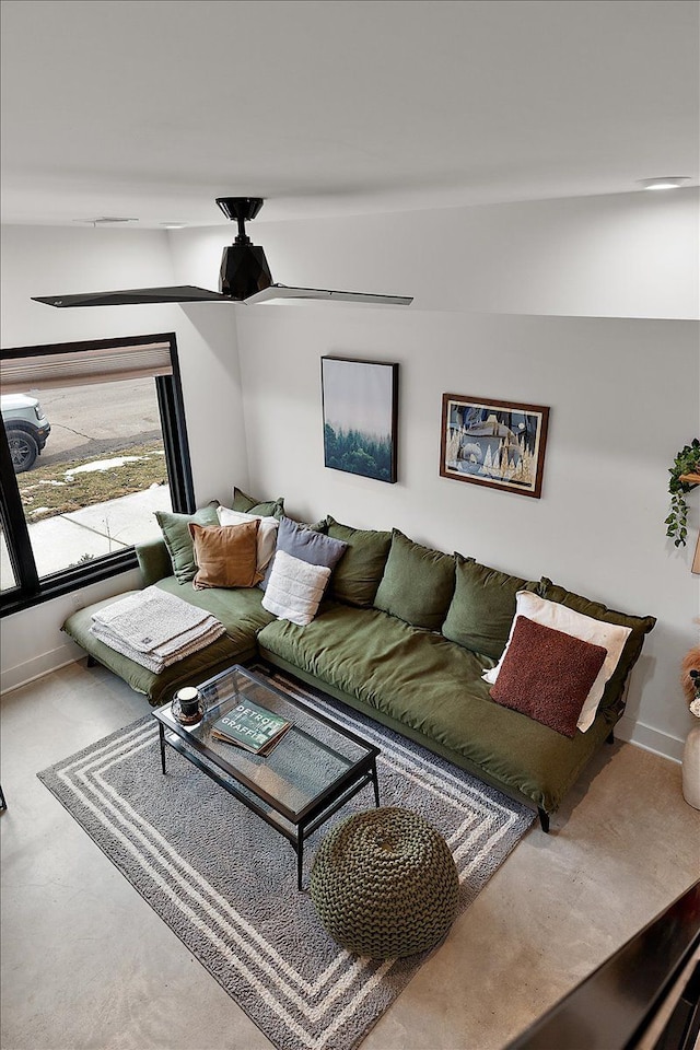 living room featuring concrete floors and baseboards