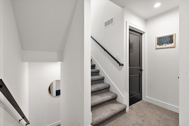 staircase featuring carpet floors, baseboards, visible vents, and recessed lighting