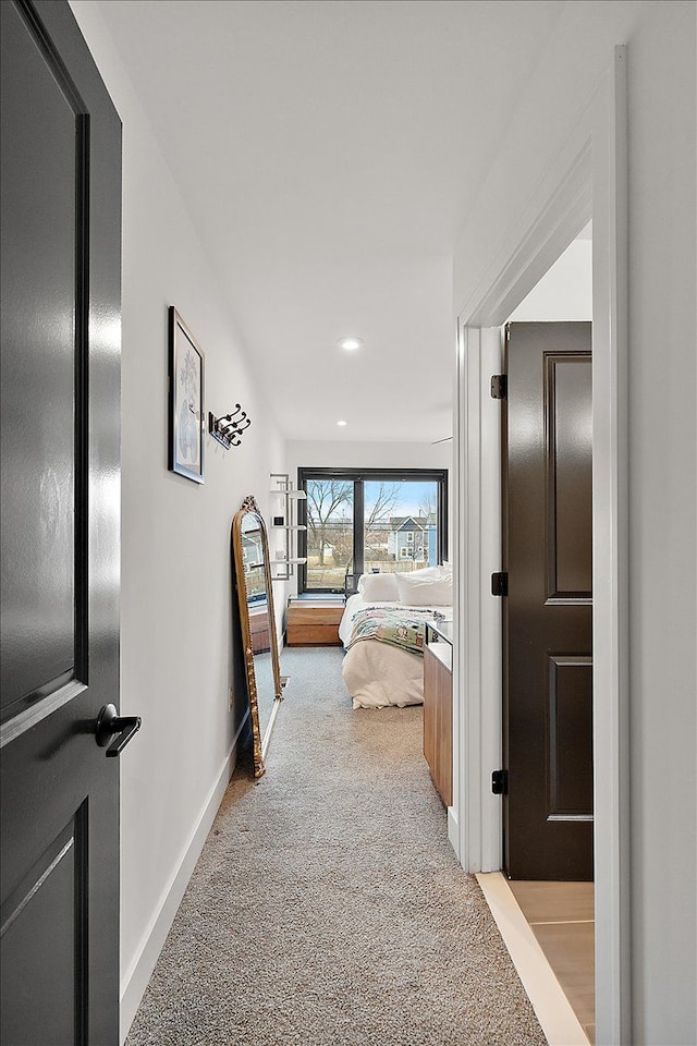 corridor featuring carpet floors, recessed lighting, and baseboards