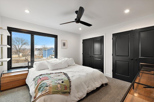 bedroom with recessed lighting, ceiling fan, and two closets