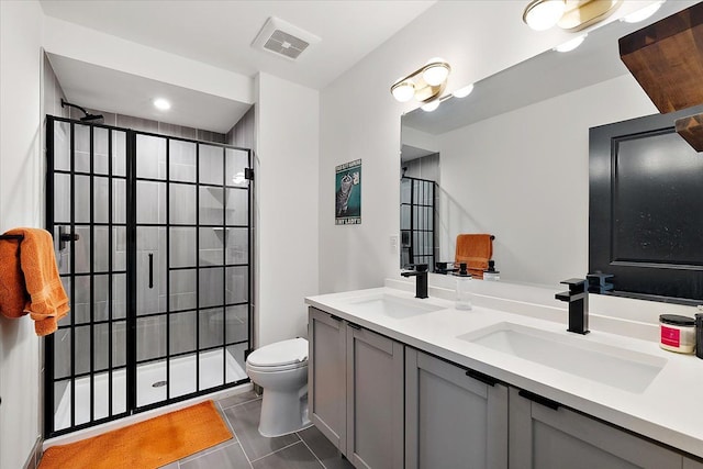 bathroom featuring visible vents, a sink, a tile shower, and toilet