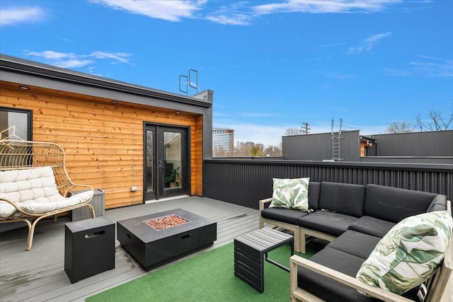 exterior space with an outdoor living space with a fire pit and a wooden deck