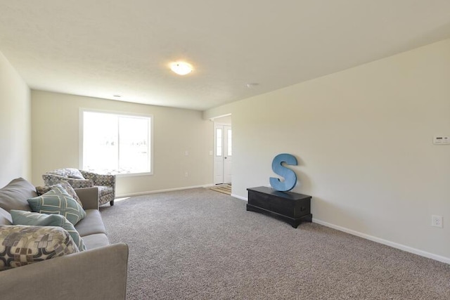 carpeted living room with baseboards