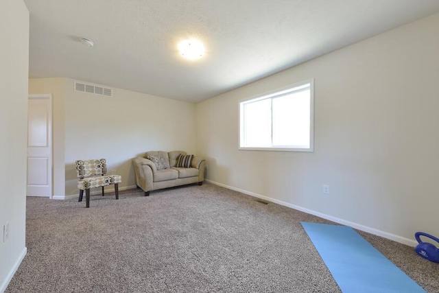 living area with carpet floors, baseboards, and visible vents