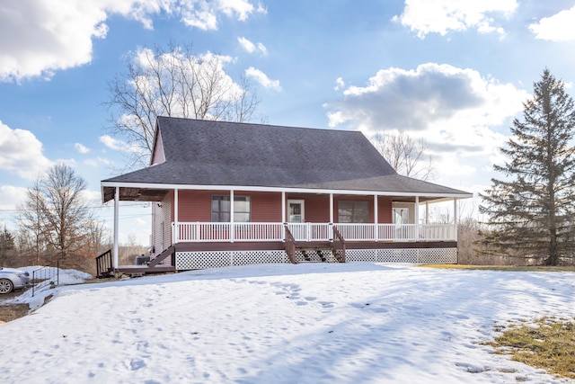 country-style home featuring a porch and a shingled roof