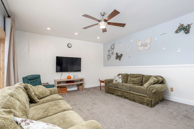 living room featuring carpet floors, recessed lighting, a wainscoted wall, and a ceiling fan