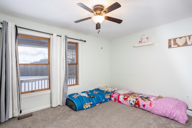 carpeted bedroom featuring visible vents and ceiling fan