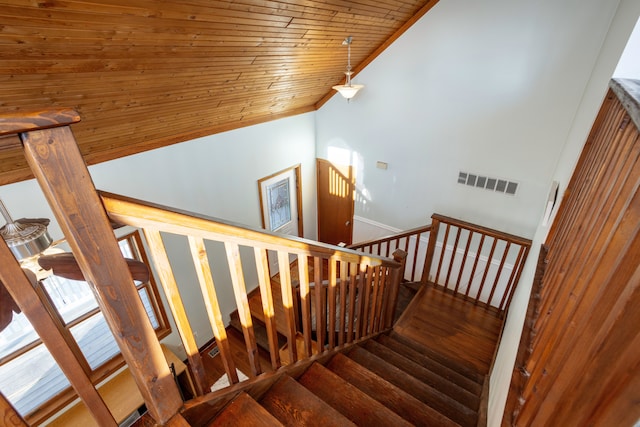 stairs with lofted ceiling, wood ceiling, visible vents, and wood finished floors