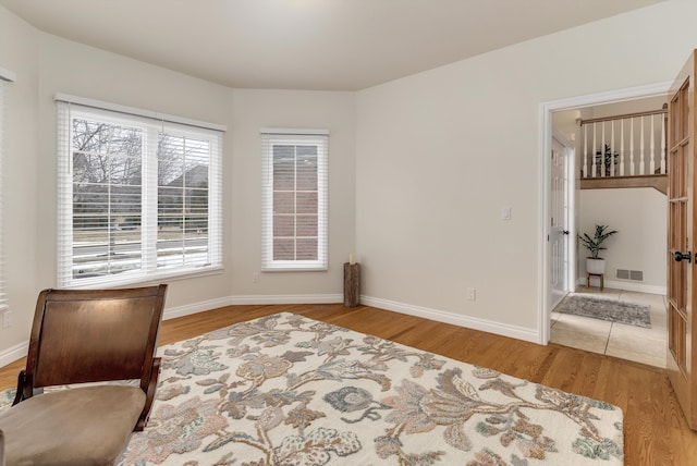 interior space featuring visible vents, baseboards, and wood finished floors