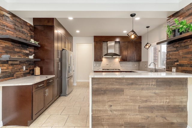 kitchen with open shelves, stainless steel appliances, backsplash, wall chimney range hood, and a peninsula