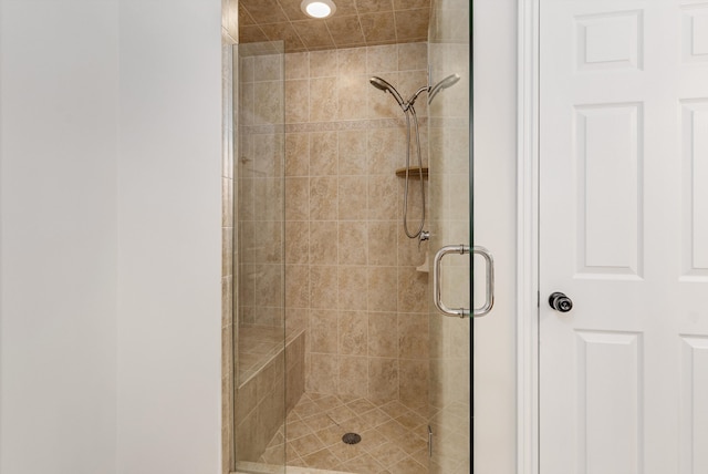 bathroom with a stall shower and recessed lighting