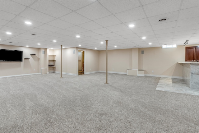 finished below grade area featuring recessed lighting, visible vents, light carpet, and baseboards