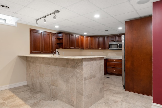 kitchen featuring visible vents, baseboards, light countertops, open shelves, and stainless steel microwave