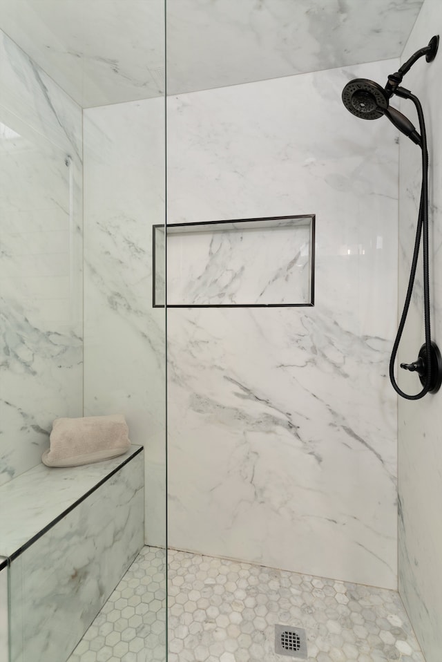 full bath featuring a marble finish shower