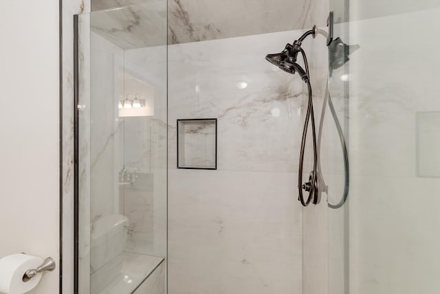 full bathroom featuring a marble finish shower