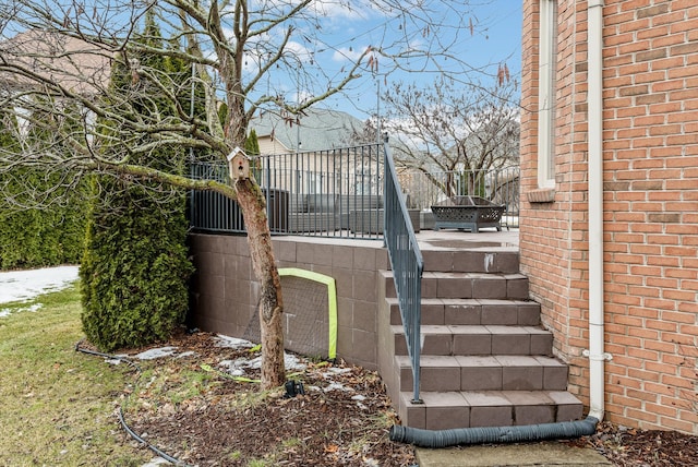 exterior space with stairs and brick siding