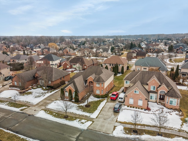 snowy aerial view featuring a residential view