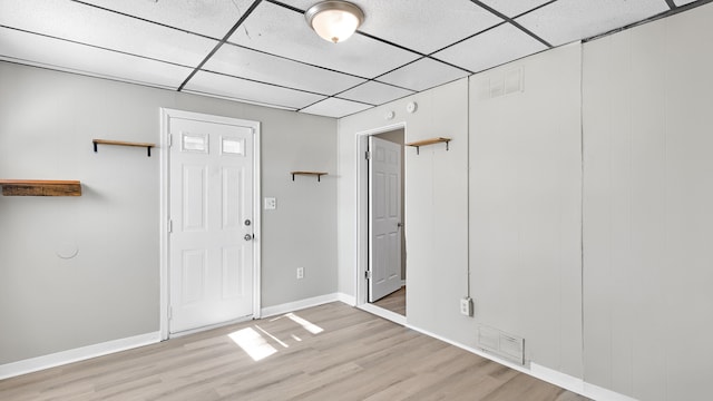 entryway featuring a paneled ceiling, visible vents, light wood finished floors, and baseboards