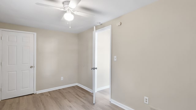 unfurnished bedroom with baseboards, light wood-style flooring, and a ceiling fan