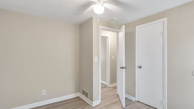 unfurnished bedroom featuring visible vents, baseboards, light wood-style floors, and ceiling fan