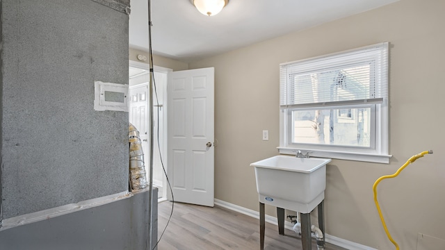 interior space with baseboards and light wood-style floors