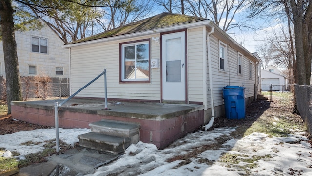 back of house with an outbuilding and fence