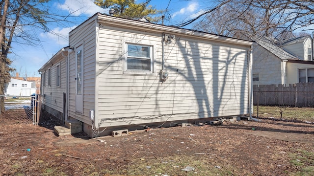 view of side of home featuring fence